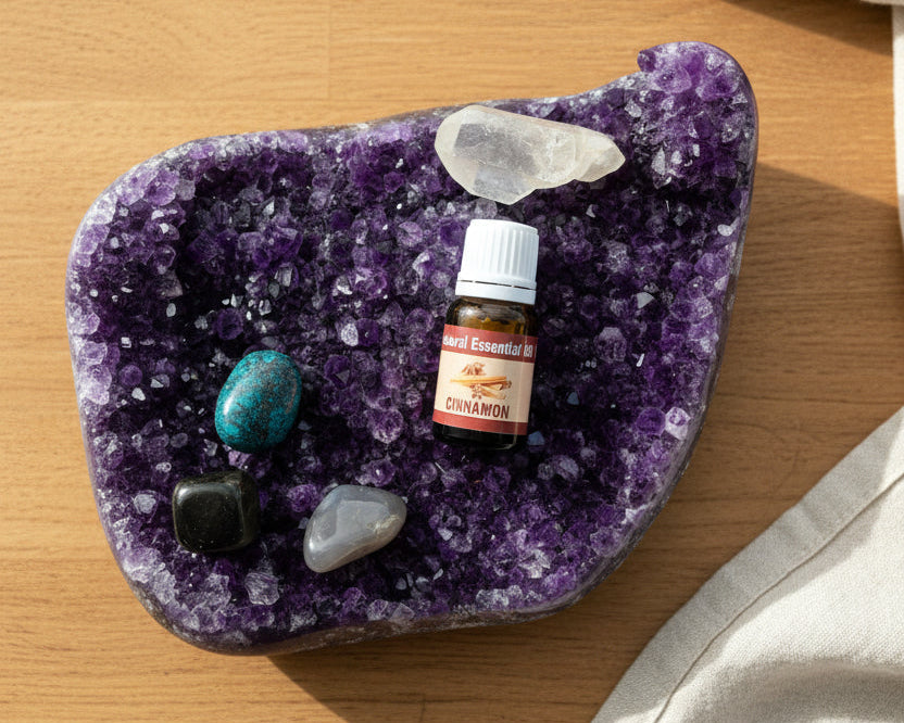 Cinnamon essential oil bottle on a raw amethyst crystal