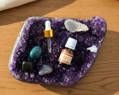 Frankincense essential oil with the glass dropper and drop reducer on amethyst