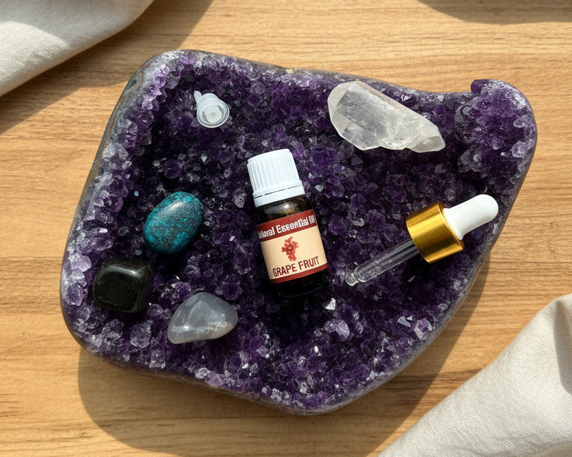 Grapefruit essential oil with the glass dropper and drop reducer on amethyst