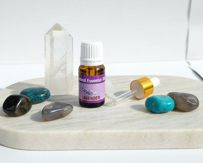Lavender essential oil with the glass dropper and drop reducer on amethyst