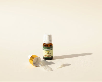 Patchouli essential oil bottle with the glass pipette dropper and push-in drop reducer