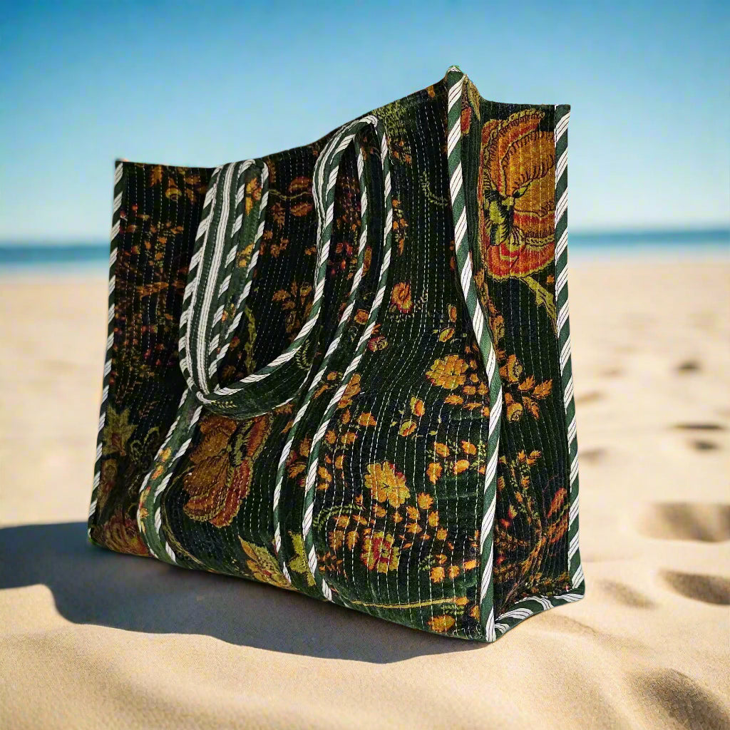side profile on beach of green quilted big velvet tote bag
